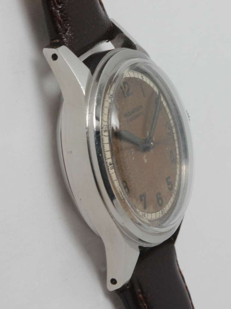 Hampden stainless steel automatic military-style wristwatch, circa 1950s.  30mm with screw back. Original patinaed dial with luminous indexes and hands. Self-winding movement with sweep seconds. On your choice of distressed strap for a sporty