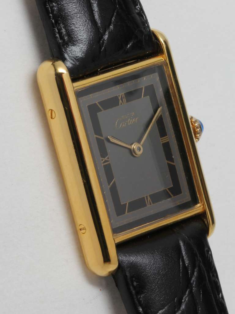 Cartier Man's Gilt Silver Vermeil Tank Louis Must de Cartier wristwatch, circa 1990s. Vermeil (20 microns gold over silver) case secured by four screws. Beautiful gray and black dial signed Must de Cartier, with fine printed gilt Roman numerals and