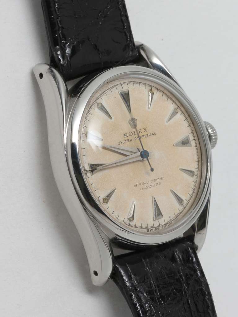 Rolex stainless steel Oyster perpetual bombé wristwatch, Ref. 5018, serial number 608,XXX, circa 1948. Rare early model with original silvered dial with raised indexes and dauphine hands. Powered by a self-winding calibre 630 movement with sweep