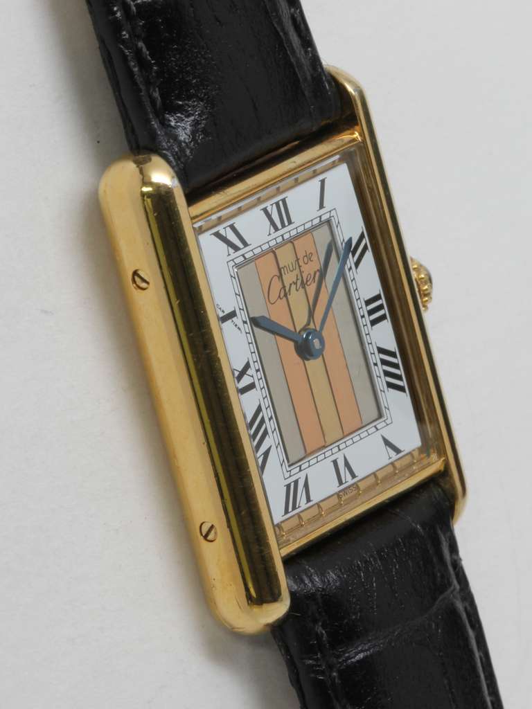 Cartier Man's gilt silver Tank Louis Must de Cartier wristwatch, circa 1990s. Vermeil (20 microns gold over silver) case secured by four screws. Lovely three-color metallic panel dial with white Roman surround, signed Must de Cartier, blued steel