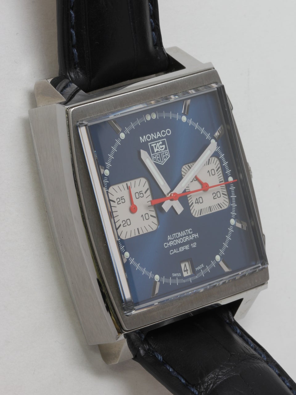 Tag Heuer Stainless Steel Steve McQueen Monaco Reissue Wristwatch ref # CCW2113.BA0780. Square 38mm case measuring 13mm thick. Blue dial with white registers at 3 and 9 o'clock.  Powered by automatic movement with date at 6 o'clock. With Tag Heuer