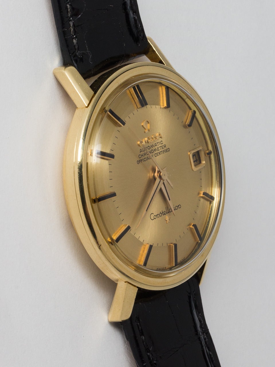 Omega 18K Yellow Gold Constellation Wristwatch, circa 1960s. 35mm case with screw down back with deeply engraved Observatory logo. Beautiful condition original champagne pie pan dial with applied gold indexes and tapered sword hands. High grade self