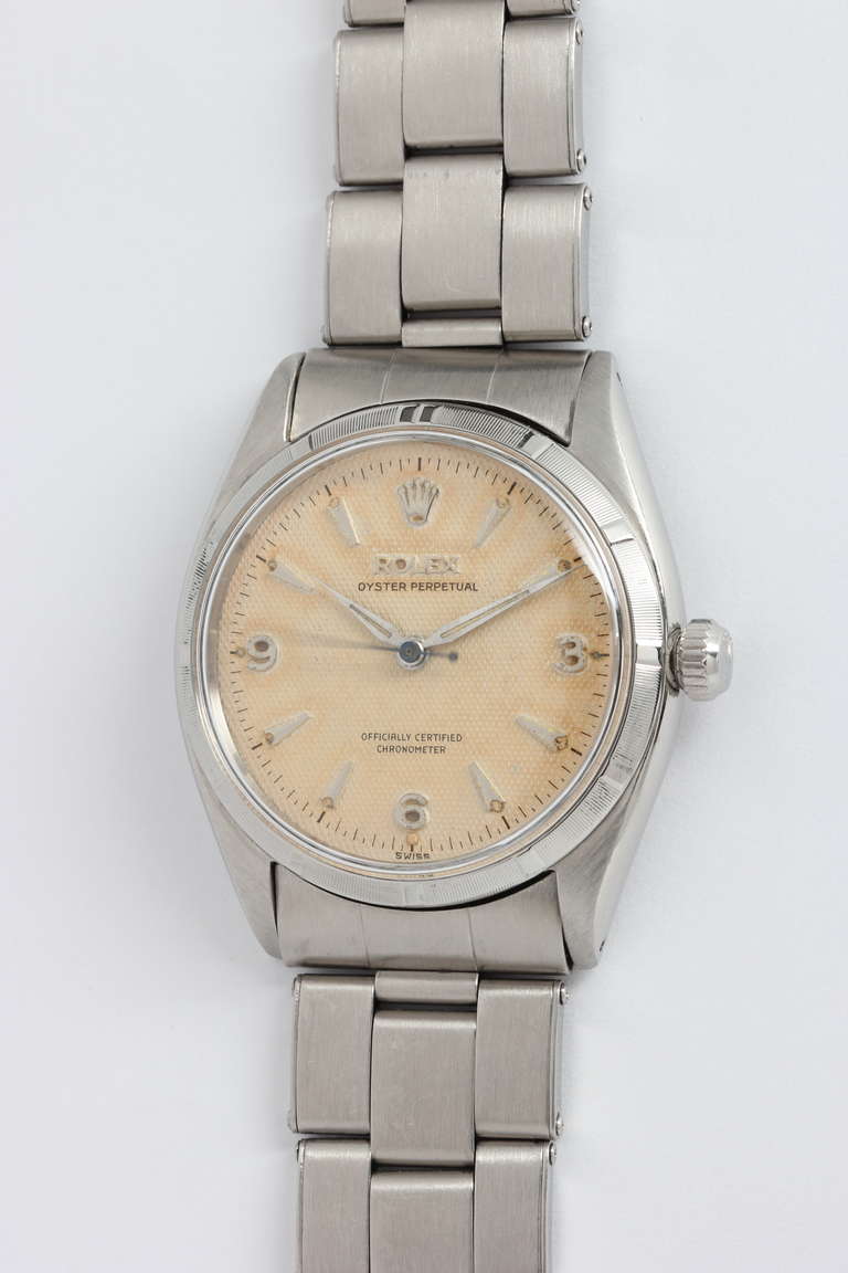 Rolex stainless steel Oyster Perpetual wristwatch, Ref. 6565, serial number 129,XXX, circa 1955. 34mm case with engine-turned bezel, acrylic crystal, and beautifully aged original dial with applied dagger indexes, applied Arabic 3, 6, 9 numerals,