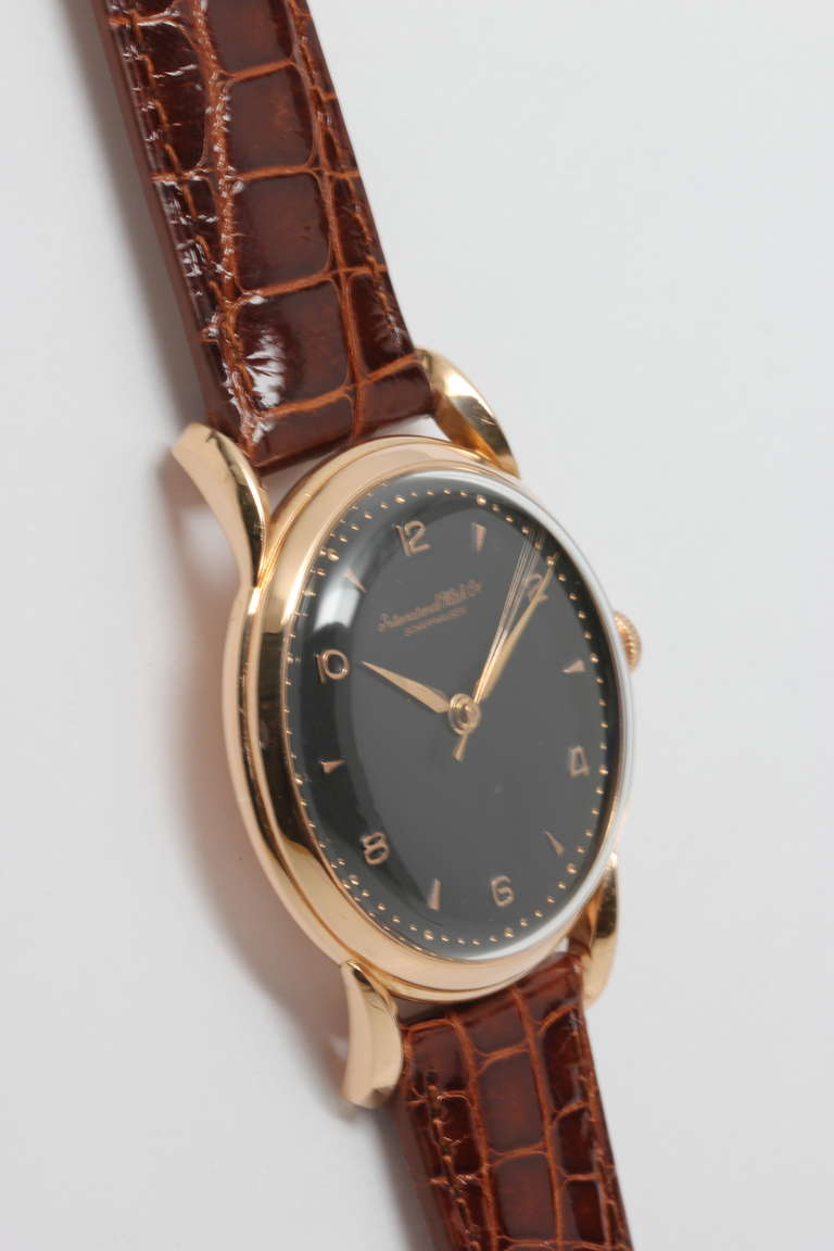 IWC 18k rose gold large and striking dress model wristwatch, 37 x 46mm, with prominent curved lugs, circa 1940s. Expertly restored black dial with fine rose gold Arabic and dagger indexes and alpha hands. Powered by calibre 89 17-jewel manual-wind