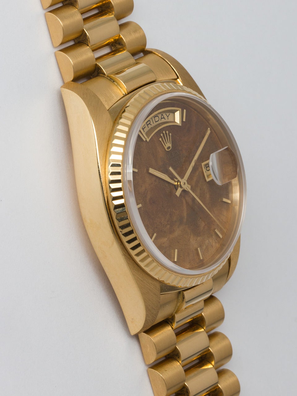 Rolex 18K Yellow Gold Day Date Wristwatch ref 18038 serial #7.6 million circa 1982/83. 36 mm diameter case with fluted bezel and sapphire crystal.  Gorgeous factory burl wood dial with gold applied markers and hands. Powered by self winding movement