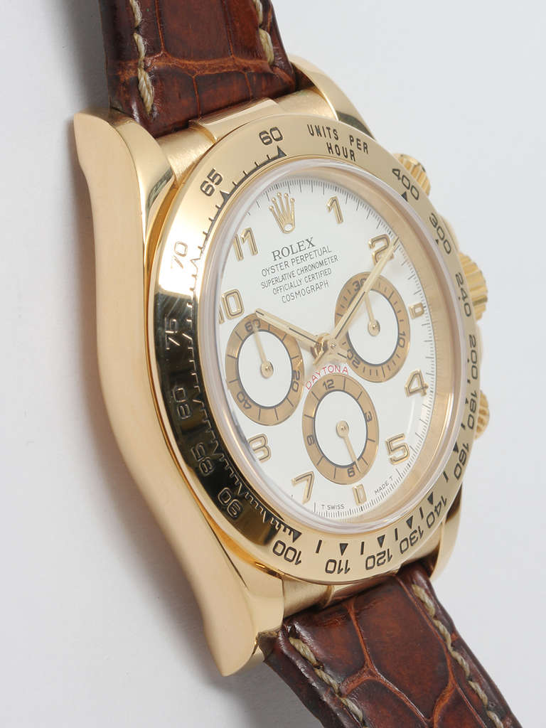 Rolex 18k yellow gold Daytona Cosmograph wristwatch, Ref. 16518, serial number W0, circa 1995. 39mm case with 18k yellow gold tachometer bezel, screw down pushers and sapphire crystal. Featuring a white dial with gold register surrounds. Powered by