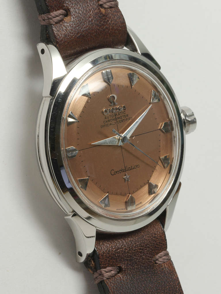 Omega stainless steel Constellation automatic wristwatch, circa 1950s. 35 x 42mm case with acrylic crystal and signed octagonal Omega crown. Featuring a beautifully restored two-tone salmon cross-hair pie-pan dial with applied arrowhead markers and