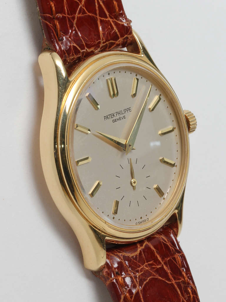 Patek Philippe 18k yellow gold manual-wind dress model wristwatch, Ref. 3923, circa 1990s. 32mm case with original matte silvered dial with gold baton indexes and dauphine hands. Powered by an 18-jewel manual-wind calibre 215 movement with