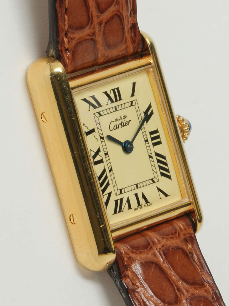 Cartier lady's gilt silver Must de Cartier Tank Louis wristwatch, Ref. 2415, circa 2000s. 20 microns of gold over silver, later style, water resistant, 22 x 29.5mm, back secured by screws. Classic cream dial signed Must de Cartier with black Roman