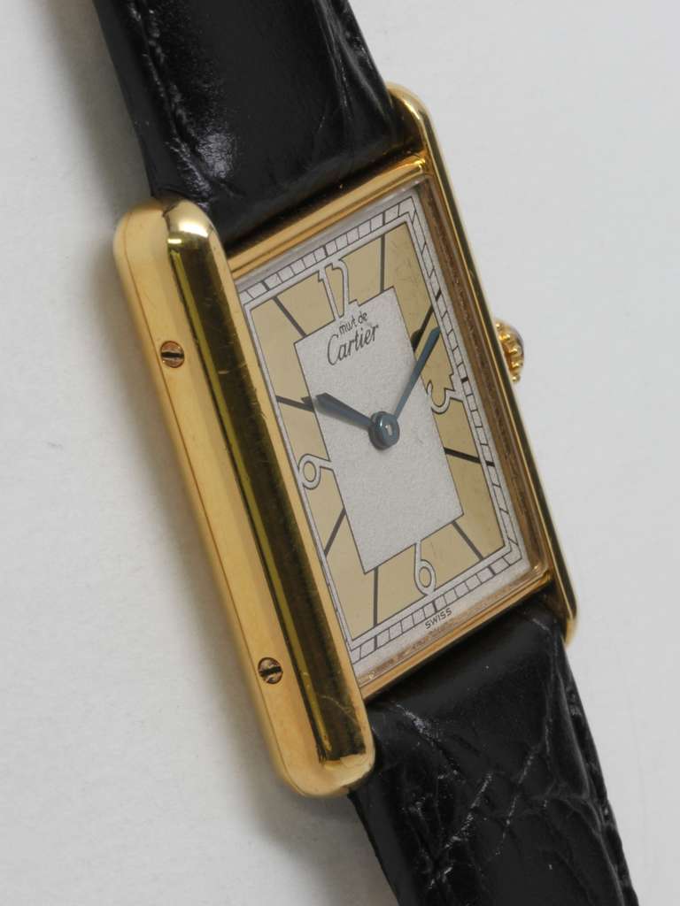 Cartier Gilt Silver Tank Louis Must de Cartier wristwatch, circa 1990s. Vermeil (20 microns gold over silver) case secured by four screws. Beautiful signed Must de Cartier silvered dial with gilt inner chapter ring, 12-3-6-9 Arabic numerals and