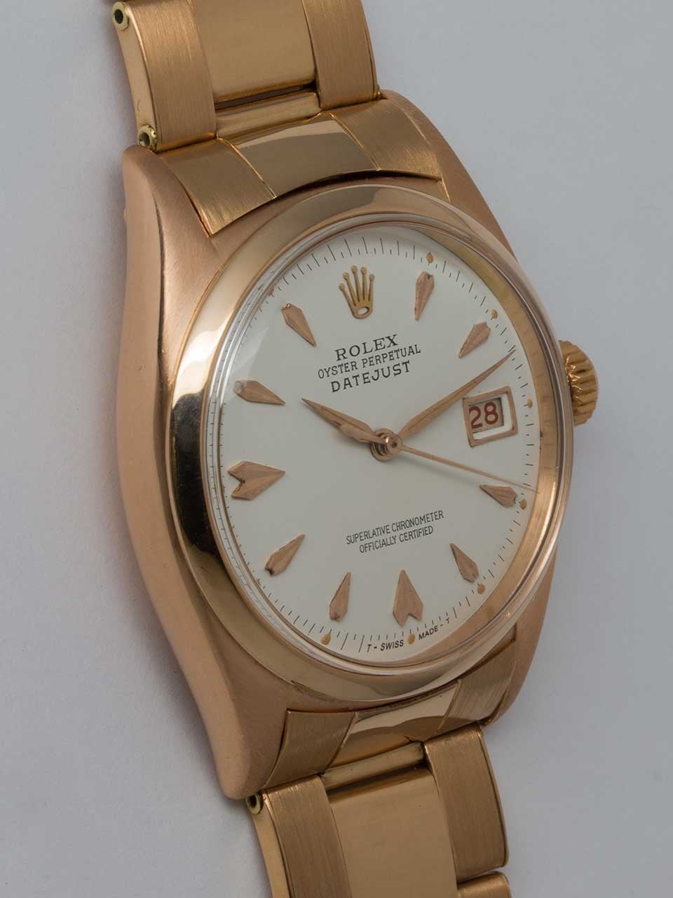 Rolex 18K Rose Gold Oyster Perpetual Datejust Wristwatch ref 6305 circa 1958. 36mm diameter case with smooth bezel and acrylic dome crystal without date magnifying cyclops. Very pleasing antique white dial with applied pink indexes and pink sword