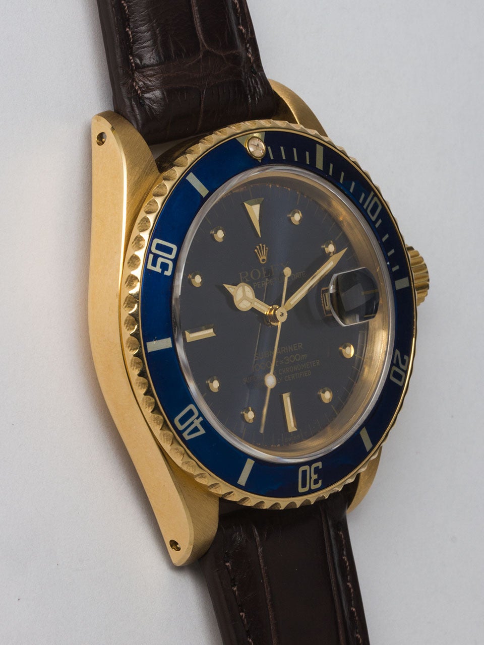 Rolex 18K Yellow Gold Submariner Wristwatch ref 16808, serial #6.4 million circa 1979. 40mm diameter case with unidirectional elapsed time bezel, lightly faded blue insert and sapphire crystal. Original blue so called 