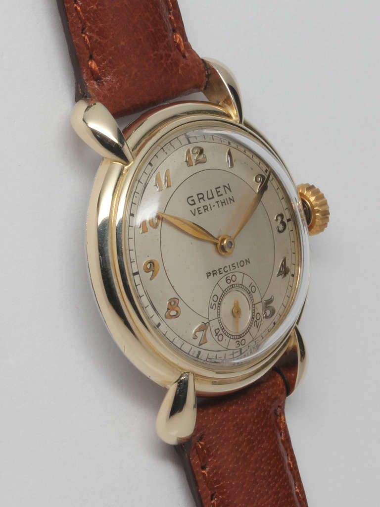 Gruen yellow gold-filled Veri-Thin wristwatch, circa 1950s. Boy's size 28.5 x 34mm case with stylized lugs and acrylic crystal. Original two-tone silvered dial with applied Breguet numerals and feuille hands. Powered by a 17-jewel manual-wind