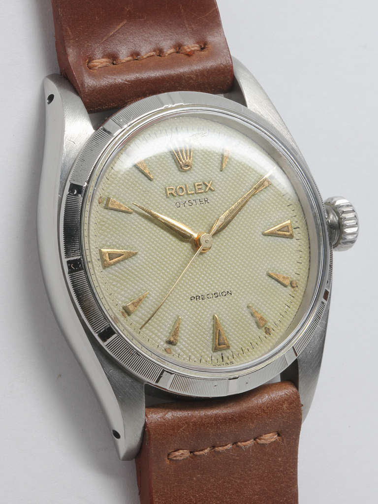 Rolex stainless steel Oyster Precision wristwatch, Ref. 6423, serial number 275,XXX, circa 1954. 34mm case with shallow engine-turned bezel, acrylic crystal, and pleasing original patinaed waffle dial with applied gold indexes and gold alpha hands.