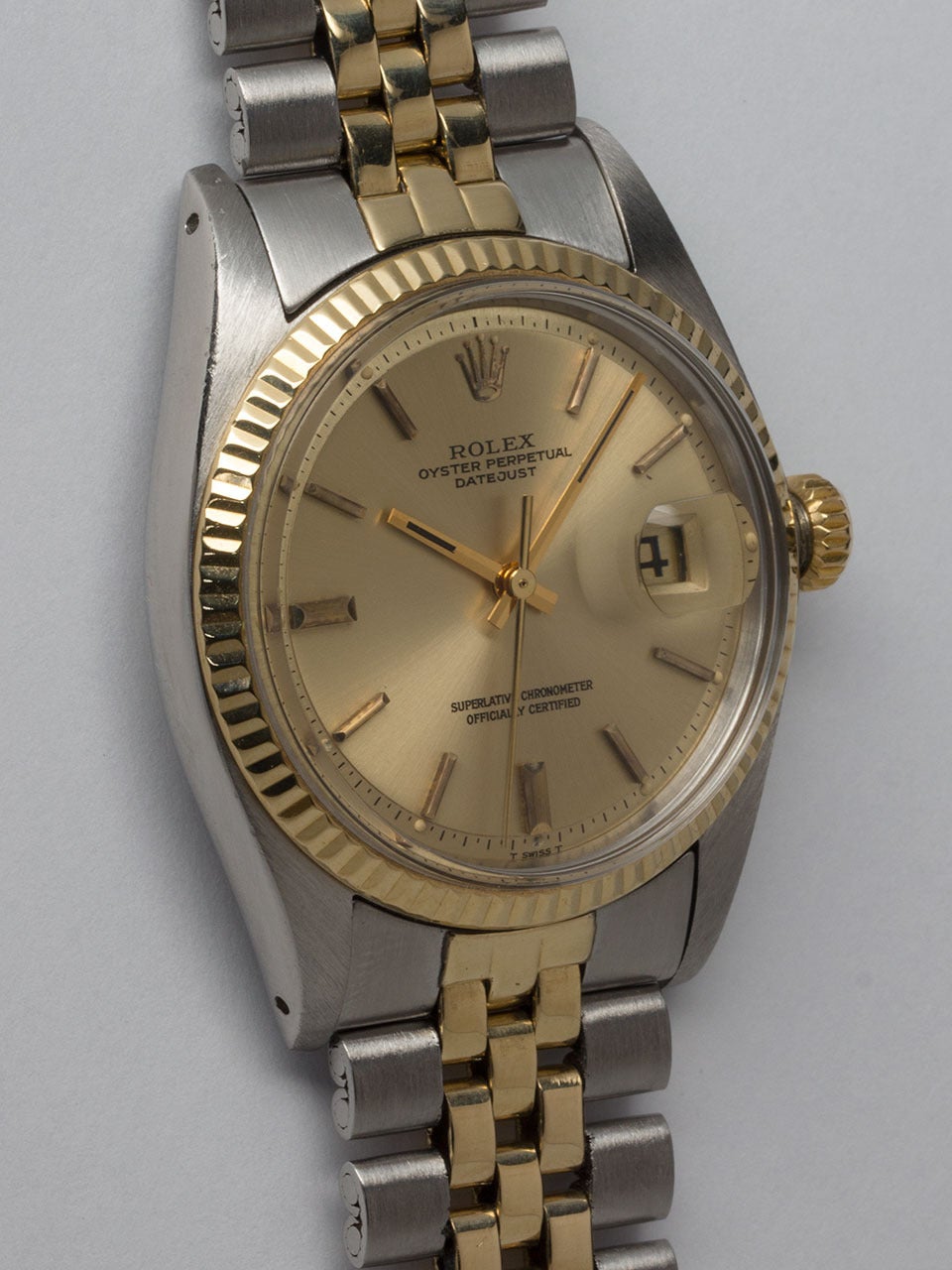 Rolex Stainless Steel and 14K Yellow Gold Datejust Wristwatch ref 1601 serial #3.8 million circa 1972. 36mm diameter case with 14K yellow gold fluted bezel and acrylic crystal. Original champagne pie pan dial with applied gold indexes and gold baton