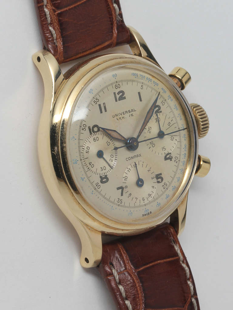 Universal 14k yellow gold Compax chronograph wristwatch, circa 1949. 34mm x 40mm diameter case with round pushers and screwed case back. Very beautiful original two-tone silvered satin three-register dial with luminous Arabic indexes and luminous