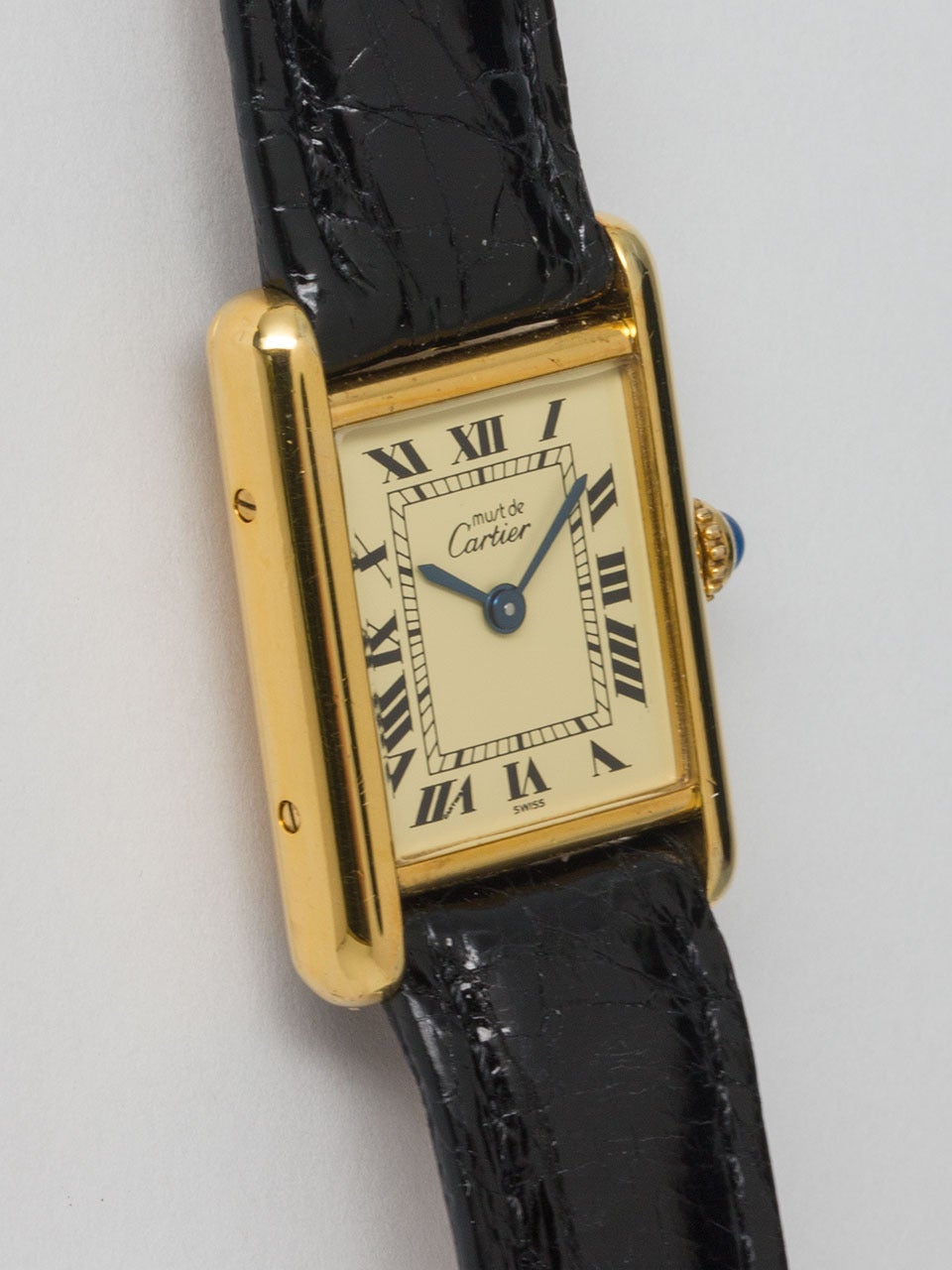 Cartier Lady's Vermeil Tank Louis Must de Cartier, circa 1990s. Vermeil, 20 microns gold over silver, case secured by 4 screws. Classic cream dial signed Must de Cartier with black roman numerals and blued steel hands. Quartz movement with cabochon