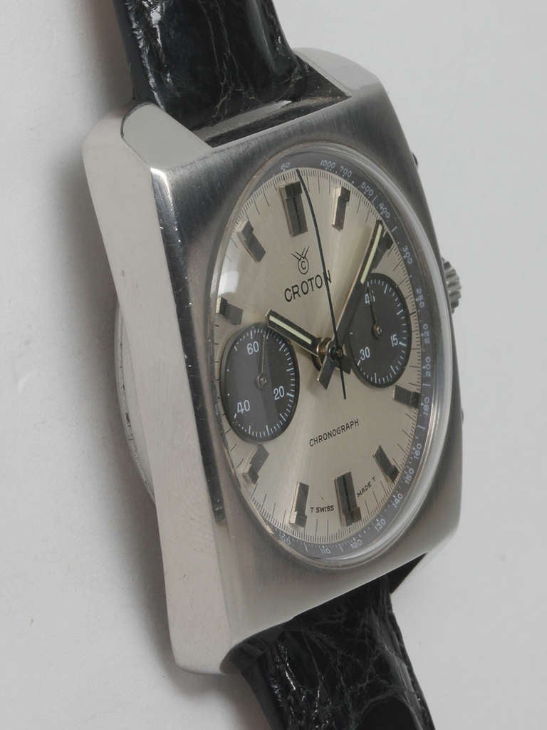 Croton stainless steel chronograph wristwatch, circa 1960s. Heavy and thick 37 X 44mm square case with screw back. Original silvered satin dial with two black registers and geometric batons and hands. Powered by a manual-wind movement. Stylish