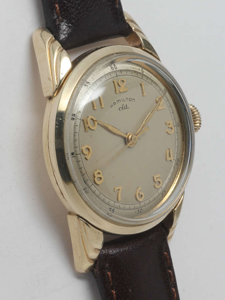 Hamilton yellow gold-filled CLD wristwatch, circa 1950. 32 x 42mm case with elongated stepped lugs, signed crown and acrylic crystal. Silvered dial with applied gold Arabic numerals and gilt feuille hands. Powered by a 17-jewel manual-wind movement