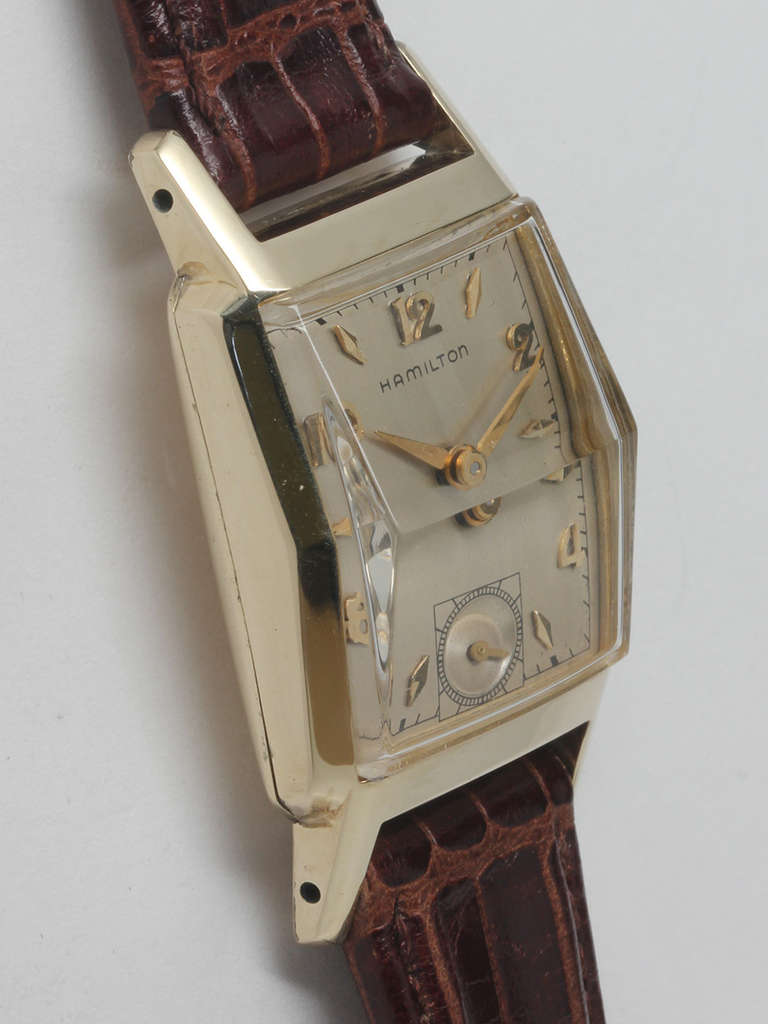 Hamilton yellow gold-filled square wristwatch, circa 1950s. 23 x 37mm case with faceted crystal. Featuring a silvered satin dial with applied indexes and hands. 17-jewel manual-wind caliber 982 movement with subsidiary seconds. Scarce medium size