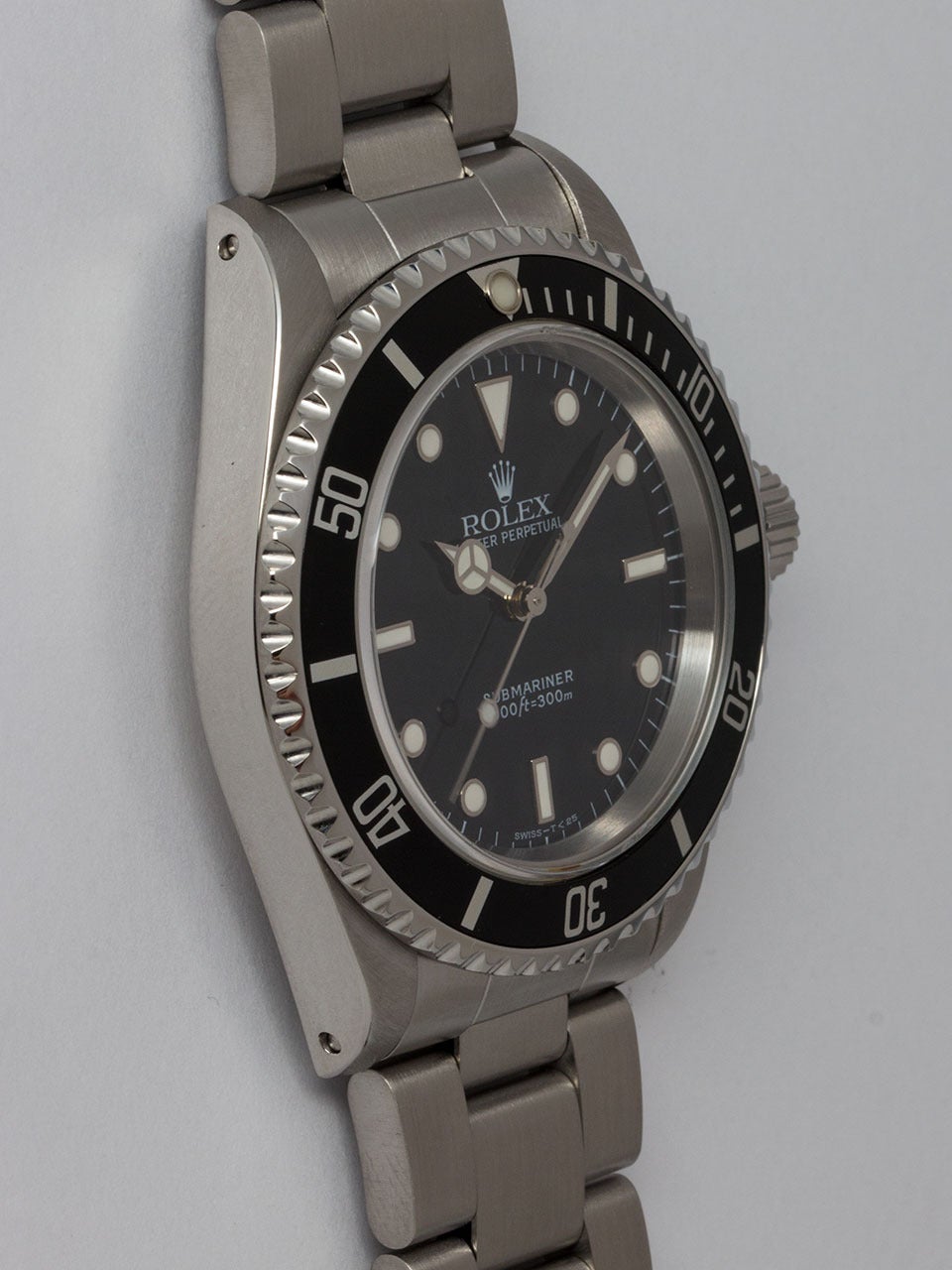 Rolex Stainless Steel Submariner Wristwatch ref 14060 serial #A5 circa 1998. 40mm diameter case with unidirectional elapsed time bezel and sapphire crystal. Glossy black original Swiss T<25 dial with white gold luminous surrounds and matching