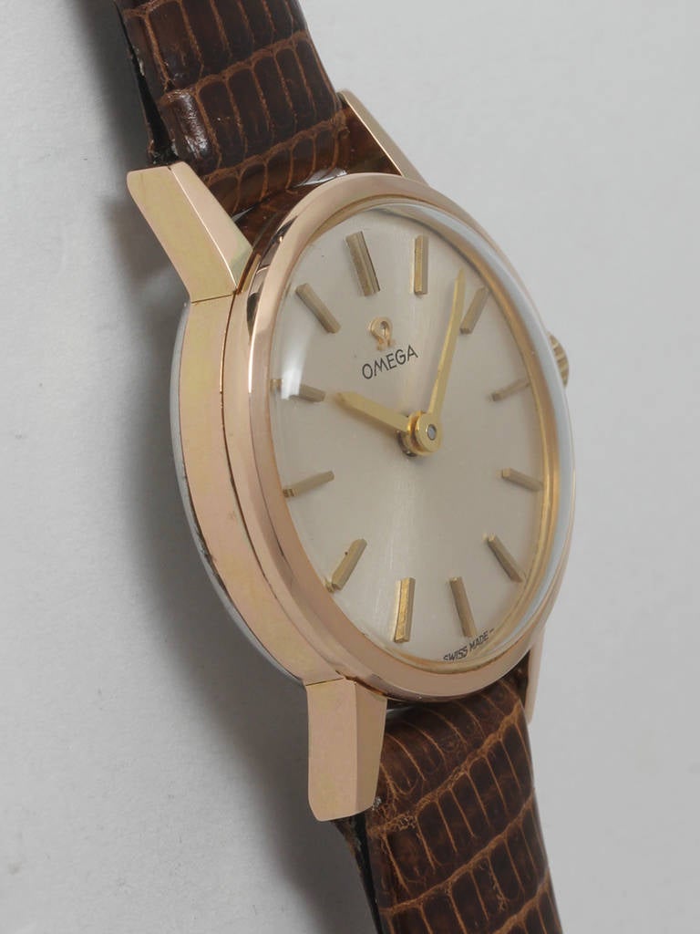 Omega lady's yellow gold-filled top and stainless steel back wristwatch, circa 1960s. 20 x 26mm case with acrylic crystal and signed crown. Original silvered dial with applied indexes and baton hands. Powered by a manual-wind movement. Classic '60s