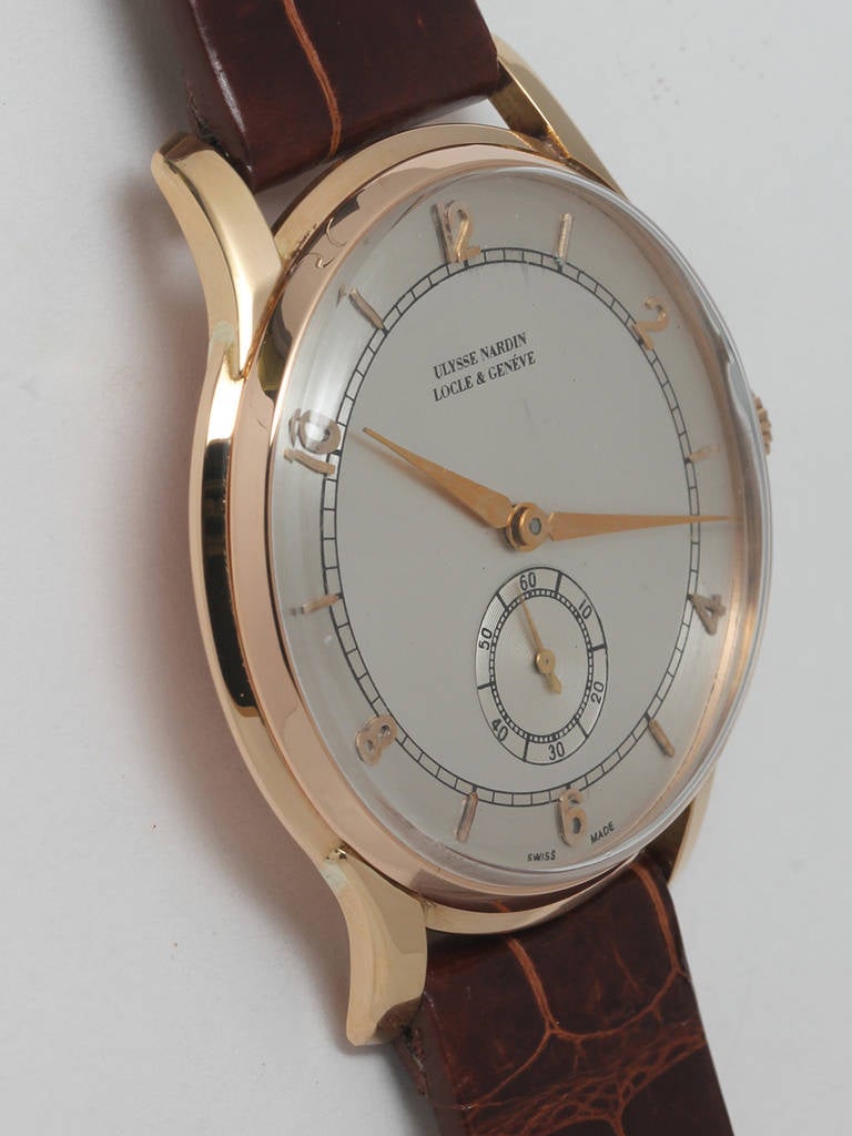 Ulysee Nardin 18k rose gold oversized wristwatch, circa 1950s. 37 x 43mm case with extended, curved lugs. Beautifully restored two-tone dial with applied Arabic and baton indexes and alpha hands. Powered by a 17-jewel manual-wind movement with