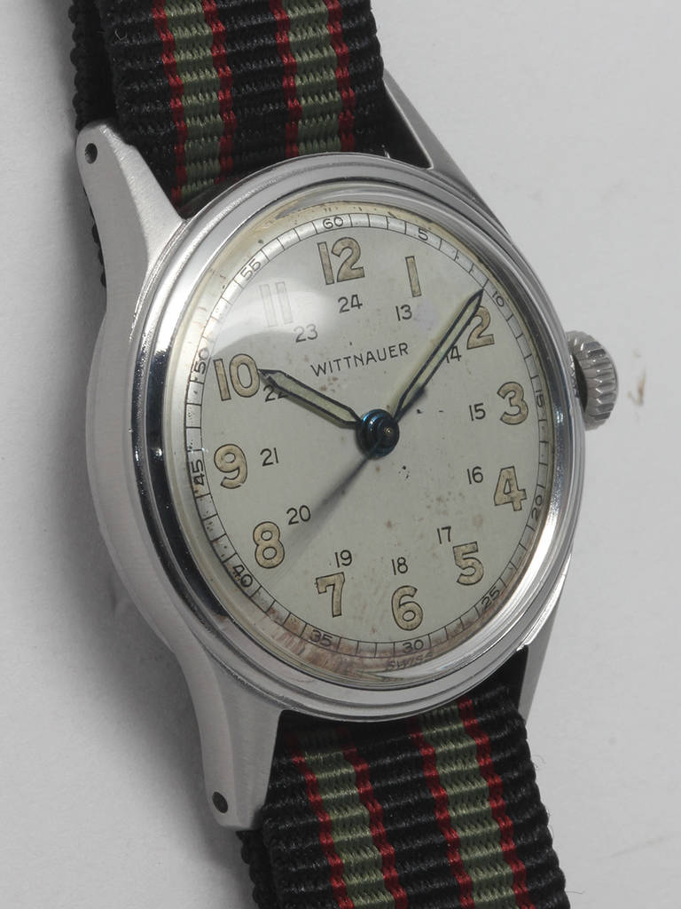 Wittnauer stainless steel military wristwatch, circa 1950s. 31 x 39mm case with brushed finish with screw back. Original matte silvered dial with luminous Arabic numerals and hands, and inner 24-hour track. 17-jewel manual-wind movement with sweep