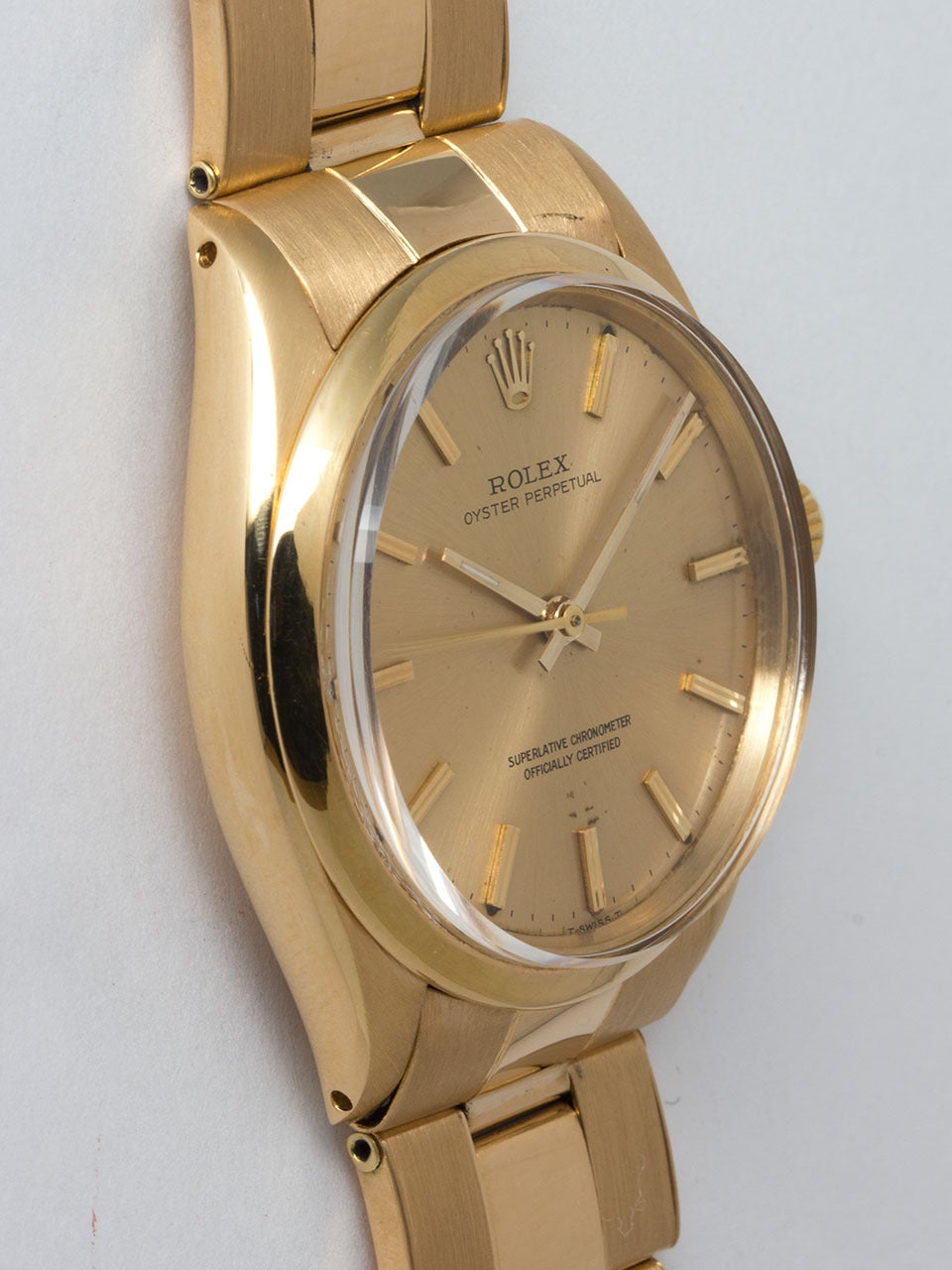 Rolex 18K Yellow Gold Oyster Perpetual ref 1005 circa 1966. 34m diameter case with smooth bezel and acrylic crystal. Original champagne dial with gold applied indexes and baton hands. Powered by  movement. With Rolex signed 18K yellow gold riveted