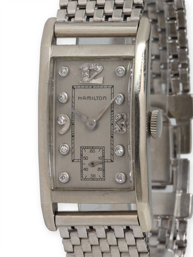 Hamilton 14K white gold rectangular and faceted case tuxedo watch with diamond set markers silver satin dial. Elongated case with contoured and faceted design. With period 14K WG heavy mesh style bracelet with clasp. Great looking vintage 1950's
