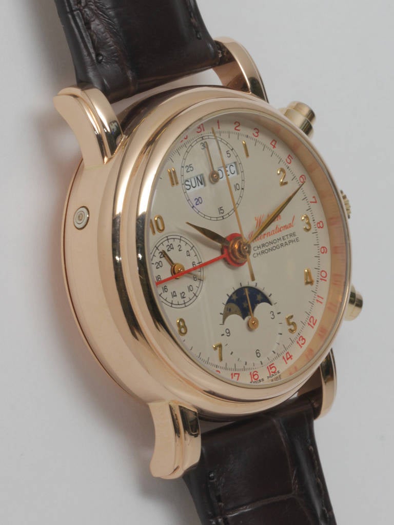 Waldan 18k rose gold automatic triple-calendar chronograph wristwatch with moonphase, retailed by Tourneau. 34 mm case with display screw back and heavy fluted lugs. Round chronograph pushers, silvered dial with applied rose gold indexes and