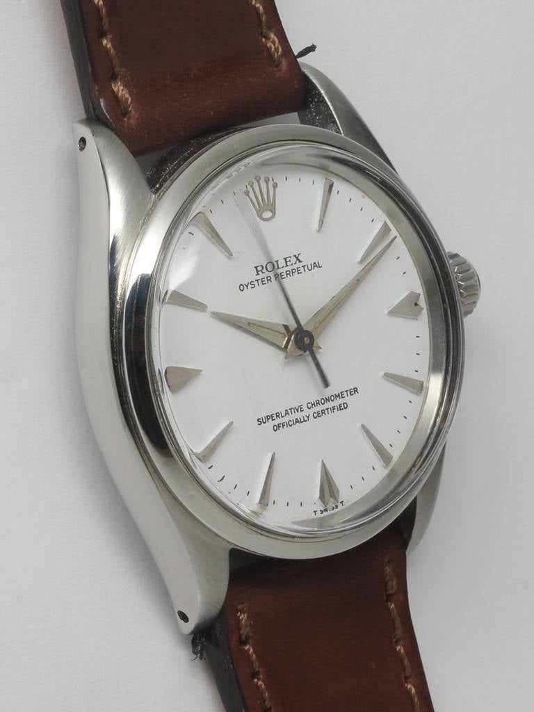 Rolex stainless steel Oyster Perpetual wristwatch, serial number 575,XXX, circa 1960. 34mm case with smooth bezel and acrylic crystal. Nicely restored white dial with raised dagger indexes and dauphine hands. Powered by a self-winding 1560 caliber