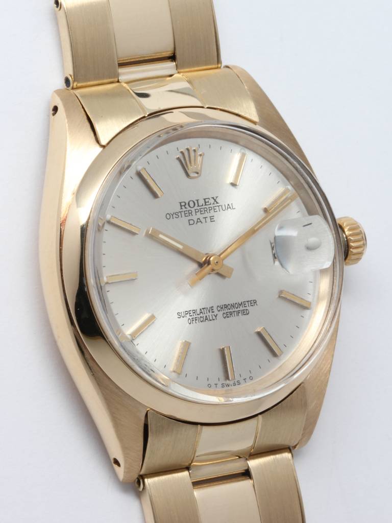 Rolex 14k yellow gold Oyster Perpetual Date wristwatch, Ref 1500, circa 1970s. 34mm case with smooth bezel and acrylic crystal. Beautiful original silvered satin dial with applied gold indexes and gold baton hands. Calibre 1570 self-winding movement