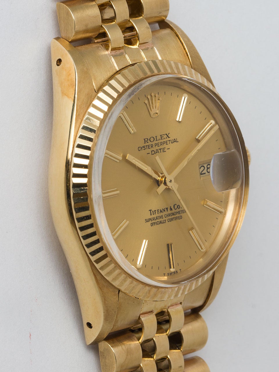 Rolex 14K Yellow Gold Tiffany & Co Oyster Perpetual Date ref 15037 serial #6.7 million circa 1981. Featuring 34mm diameter case with fluted bezel and  acrylic crystal. Original Tiffany & Co signed champagne dial with applied gold indexes and hands,
