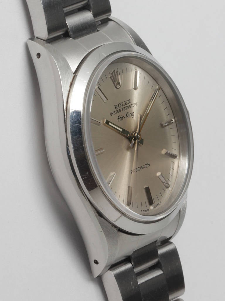 Rolex stainless steel Airking wristwatch, Ref. 14000, serial number E8, circa 1990. 34mm case with smooth bezel and sapphire crystal. Original silvered satin dial with applied baton indexes and baton hands. On a Rolex stainless steel heavy Oyster