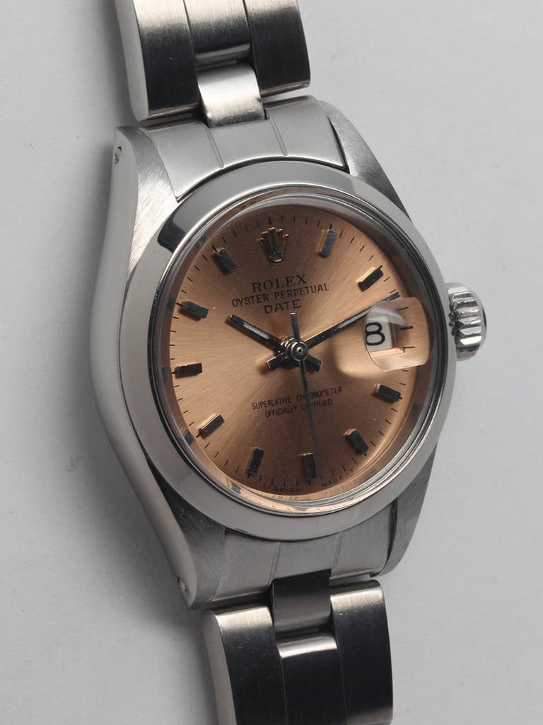 Rolex lady's stainless steel Oyster Perpetual Date wristwatch, Ref. 6916, circa 1971. 27mm case with smooth bezel, acrylic crystal and very pleasing restored salmon dial with applied markers and baton hands. Powered by a self-winding movement with