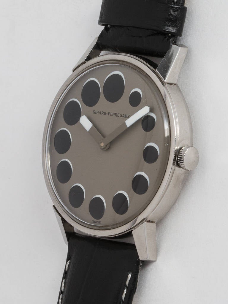 Girard-Perregaux stainless steel wristwatch, circa 1970s. 34mm case with acrylic crystal. Dramatic dial design featuring a dark gray field and graduating black round indexes with white shadow, resembling a lunar eclipse. Wide stylized hands with