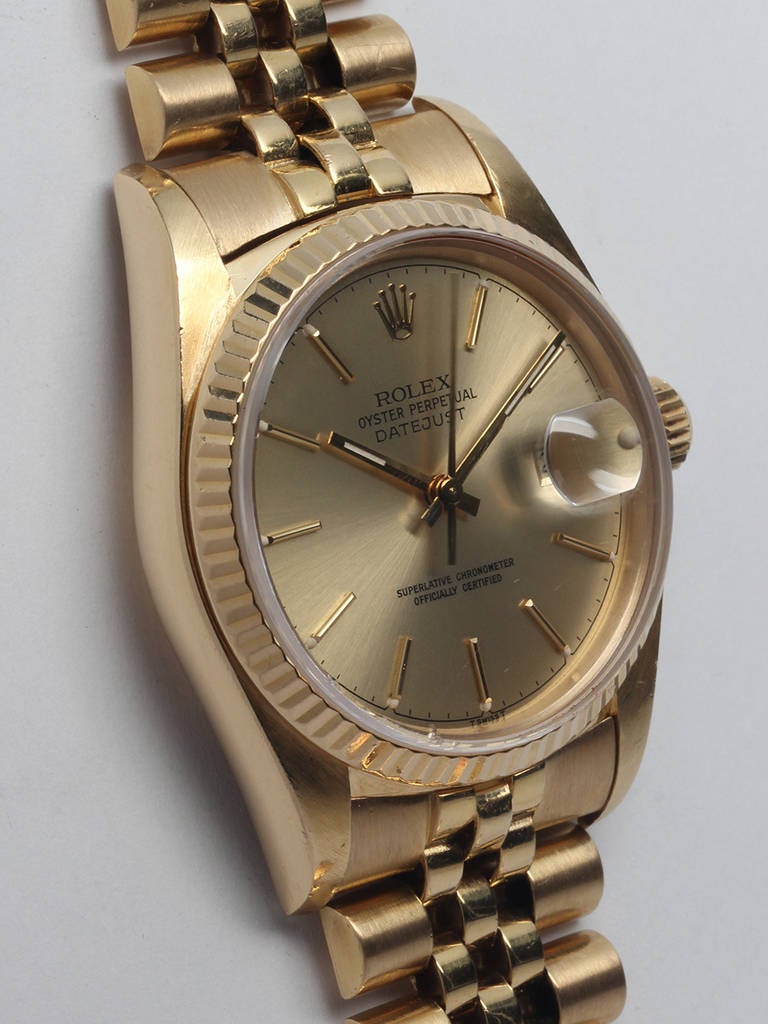Rolex 18k yellow gold Datejust wristwatch, Ref. 16018, serial number 9.0 million, circa 1985. 36mm full size man’s model with fluted bezel and sapphire crystal. Original champagne dial with applied gold indexes and gold baton hands. Self-winding