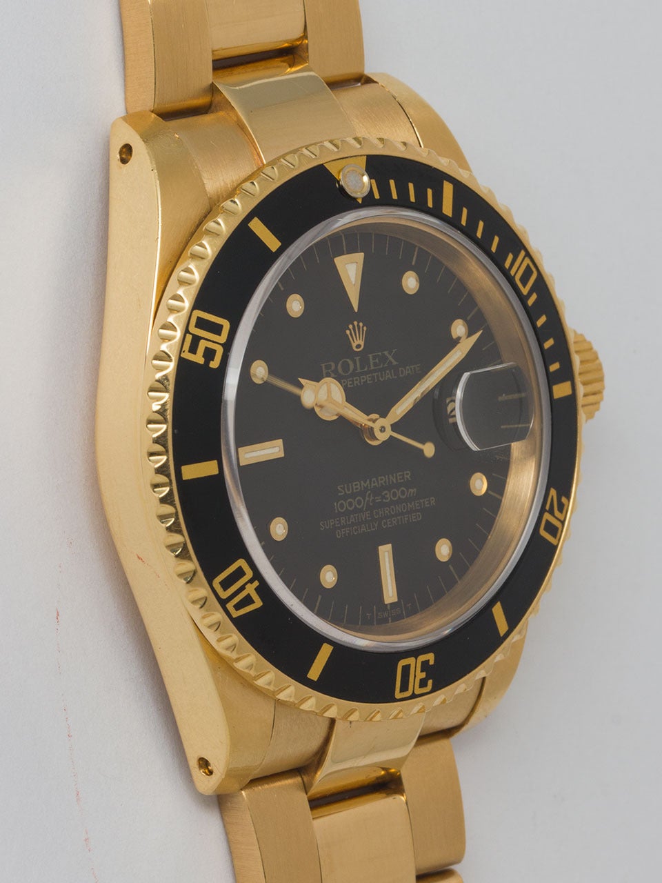 Rolex 18K Yellow Gold Submariner Wristwatch ref 16808, serial #8 million, circa 1983. Exceptional condition example of this classic early sapphire crystal model, case has heavy beefy lugs and unidirectional elapsed time bezel with black insert. With