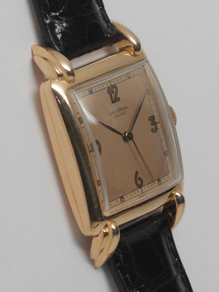 Universal 18k Rose Gold Square Wiristwatch circa 1950s. Large for the era, 30 X 42mm, domed case, with pronounced, articulated horn lugs. Very pleasing original two-tone salmon-color dial with pink baton hands. 17-jewel manual-wind calibre 263