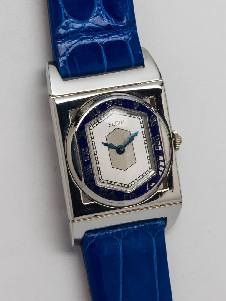 Elgin 14K white gold wristwatch with enamel bezel and hinged lugs, circa 1929. Rectangular case, blue enamel hexagonal bezel. Featuring a two-tone silvered dial with black chapter ring, original blued steel gothic-style hands. Powered by a 17-jewel
