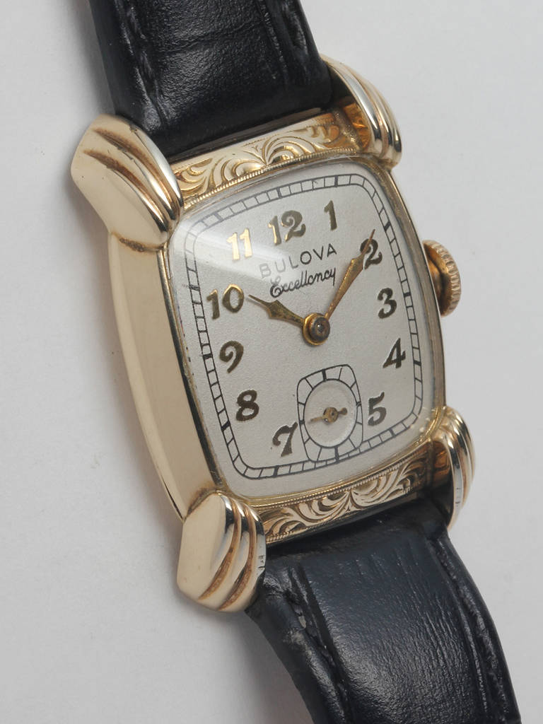 Bulova yellow gold-filled Excellency model wristwatch, circa 1940s. Cushion case with engraved bezel, fluted lugs and low dome crystal. Matte silvered dial with gilt raised Arabic figures. Powered by a 17-jewel manual-wind movement with subsidiary