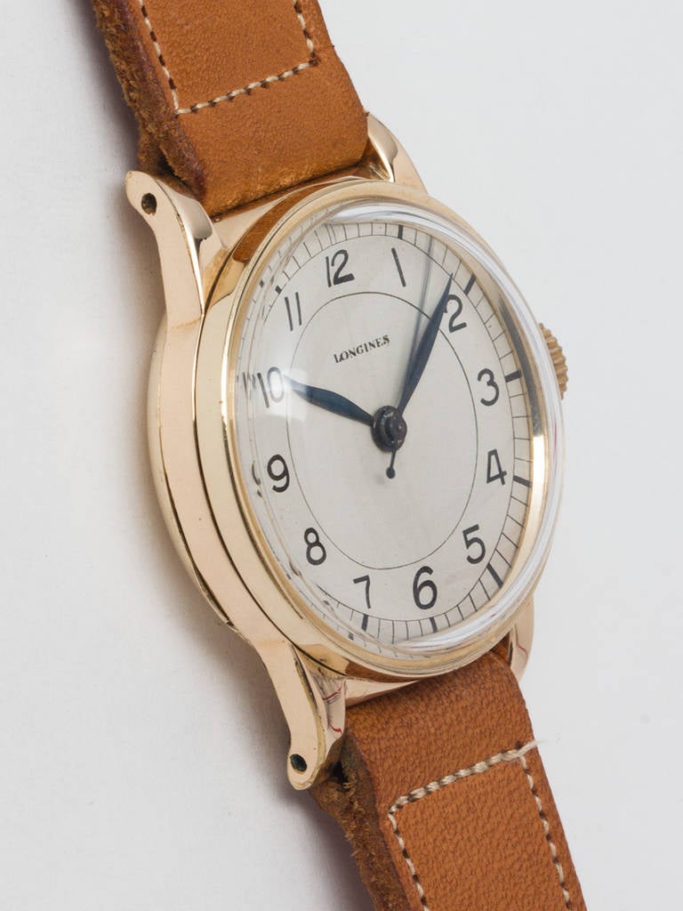 Longines yellow gold-filled wristwatch, circa 1940s.  31 x 38mm heavy snap back case. Silvered sector dial with black printed figures and blue steeled hands. Longines calibre 12L 17 jewel manual-wind movement with sweep seconds. Shown with vintage