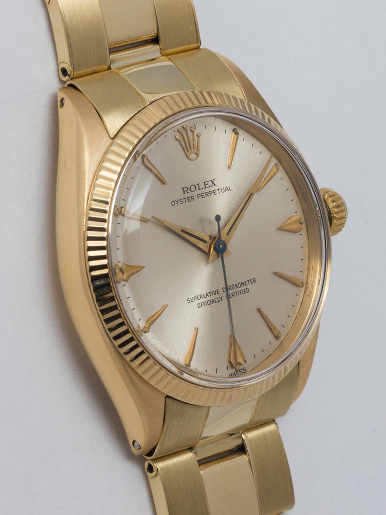 Rolex 14k yellow gold Oyster Perpetual wristwatch, Ref. 1005, serial number 989,XXX, circa 1963. 34mm case with fluted bezel, acrylic crystal, and original silvered satin dial with early applied gold dagger indexes and tapered gold hands.