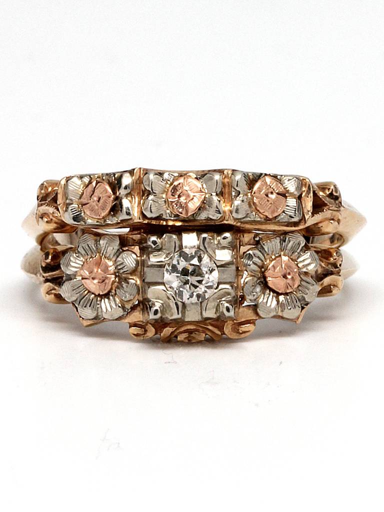 New old stock 1940's wedding set. Old european cut center diamond, 0.10 carat. 14K yellow, white and pink gold setting with floral motif design with matching wedding band with floral design.

One resizing offered with purchase. Please allow one