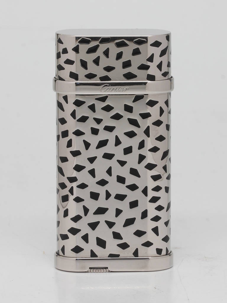Cartier Panther Butane Lighter, circa 2000s. Striking design with Panther spots decor in palladium finish with black lacquer. Signed Cartier Swiss Made. Lighter measures 60mm x 29mm. 

Stk# 44528