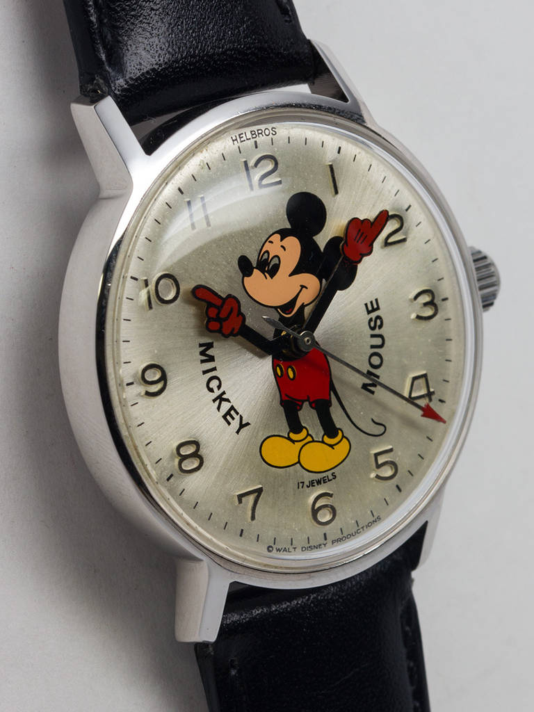 Adult-size Helbros stainless steel Mickey Mouse wristwatch, circa late 1970s.  34 x 39mm, with acrylic crystal. Silvered dial with raised numbers and colorful image of Mickey with animated red gloved hands. Powered by a 17-jewel manual-wind movement