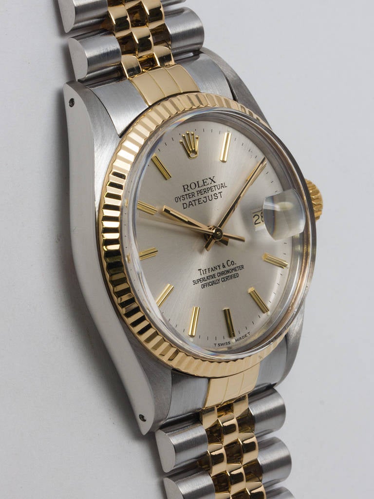 Rolex stainless steel and 14k yellow gold Datejust wristwatch, Ref. 1603, serial number 8.9 million, circa 1985. 36mm case with fluted bezel and sapphire crystal. With Tiffany & Co silver satin dial with applied gold indexes and hands. Powered by