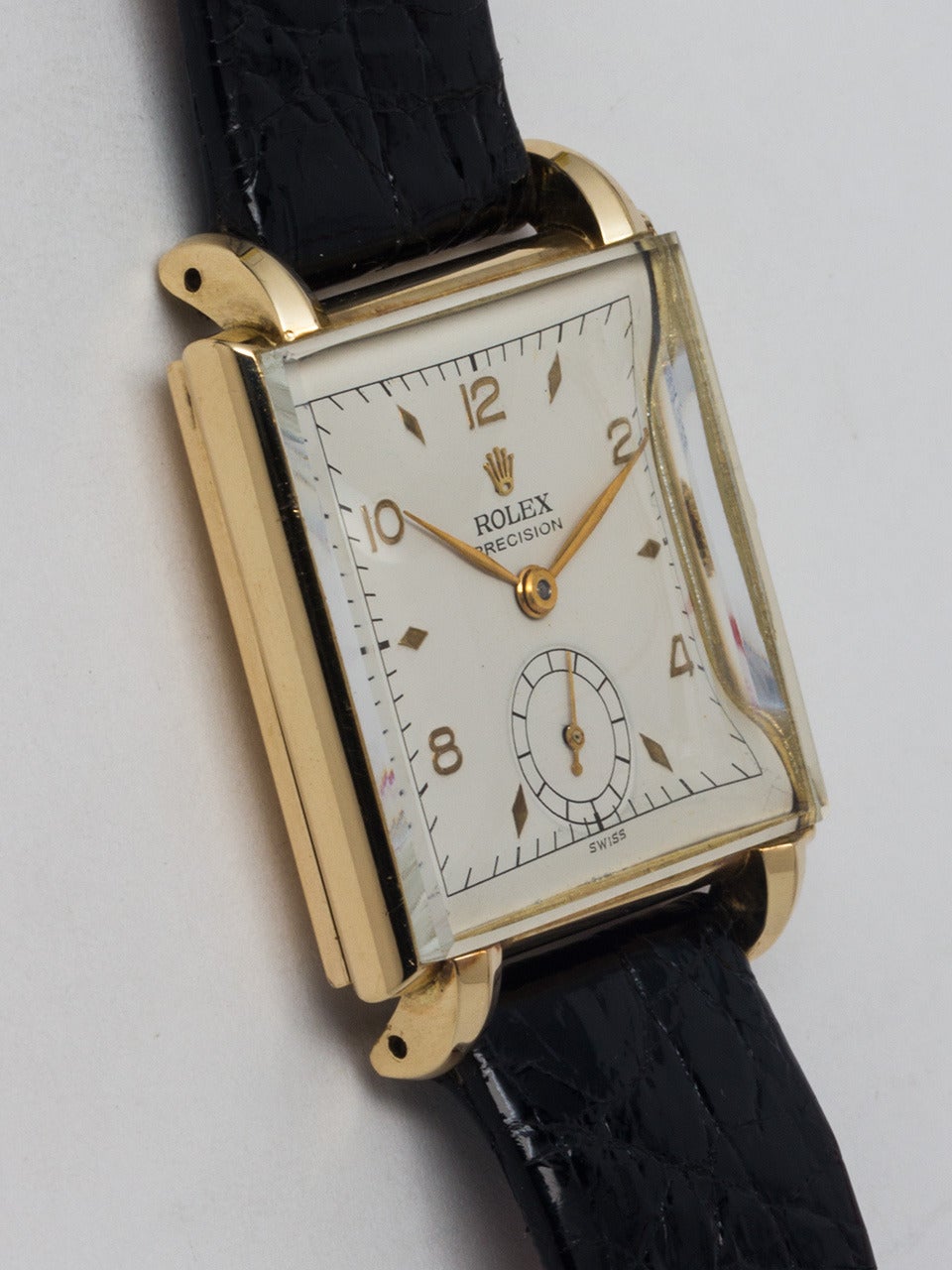 Rolex 14K yellow gold square wristwatch, circa 1950s. 28 X 36mm heavy case with claw lugs and mushroom-style crown. Very pleasing restored dial with raised gold indexes and gold leaf hands. Powered by a calibre 10 1/2 H 17-jewel manual-wind movement