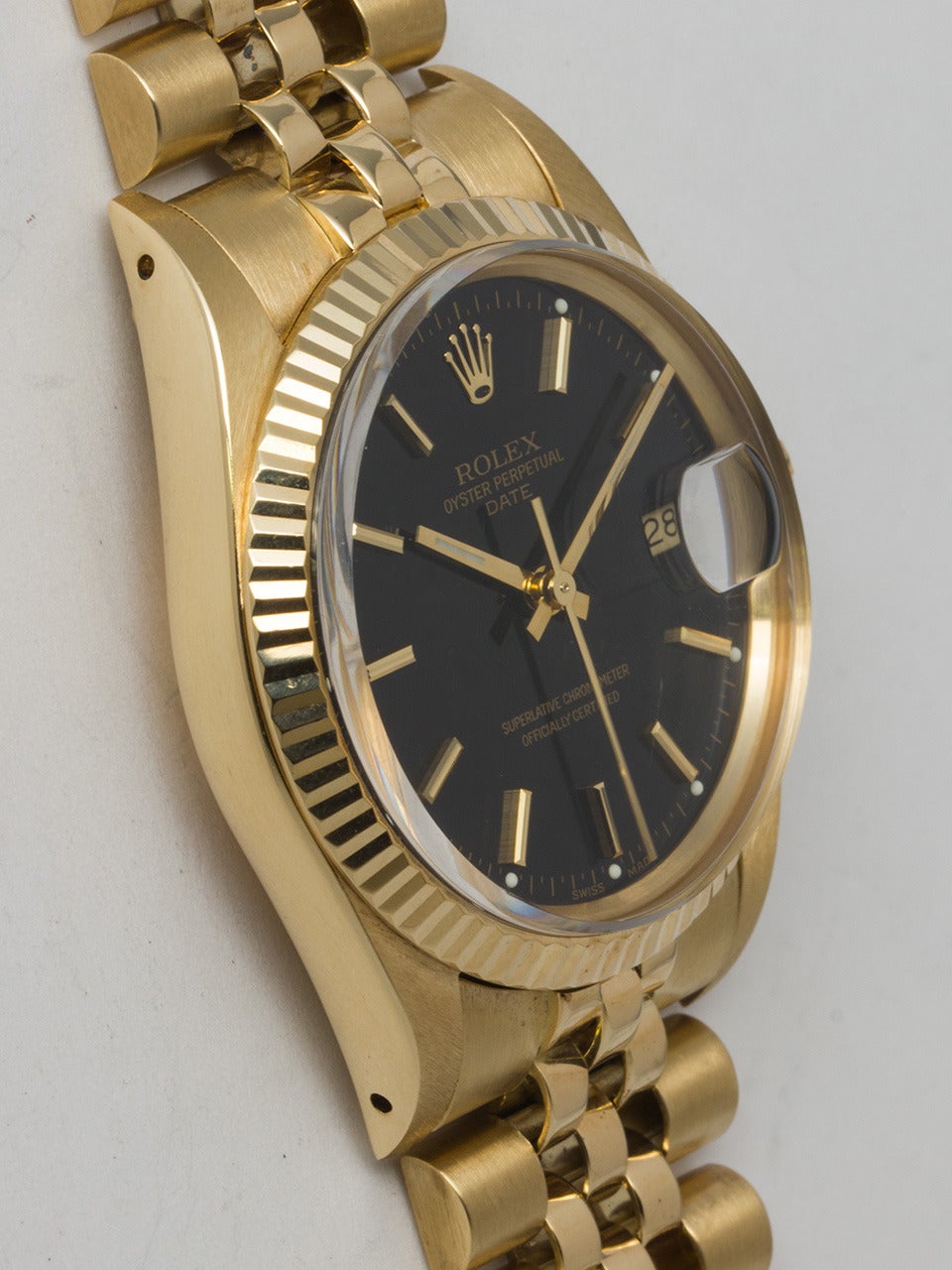 Rolex 14k Yellow Gold Oyster Perpetual Date Wristwatch, Ref. 15038, circa 1989. 34mm case with fluted bezel and acrylic crystal. Beautiful original glossy black dial with applied gold indexes and gold baton hands. Powered by a self-winding calibre